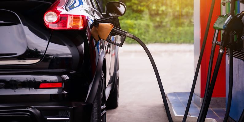 Pumping gasoline fuel in car at gas station